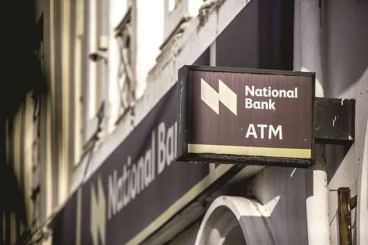 A logo sits on display outside a National Bank of Kenya branch in Mombasa, Kenya (file). The gross domestic product in East Africau2019s largest economy expanded by 4.4% from a year earlier in the three months through September, compared with 5% reported in the previous quarter, the Kenya National Bureau of Statistics said on its website.