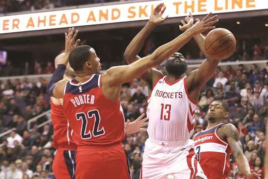 Houston Rockets guard James Harden (second from right) is fouled while shooting the ball by Washington Wizards forward Otto Porter Jr. in the first quarter of their NBA game at Capital One Arena in Washington, DC, on Friday. (USA TODAY Sports)