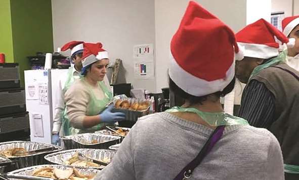 Volunteers at the Curve community centre near Grenfell Tower serve Christmas lunch to more than 250 people from North Kensington, including survivors of Juneu2019s fire.