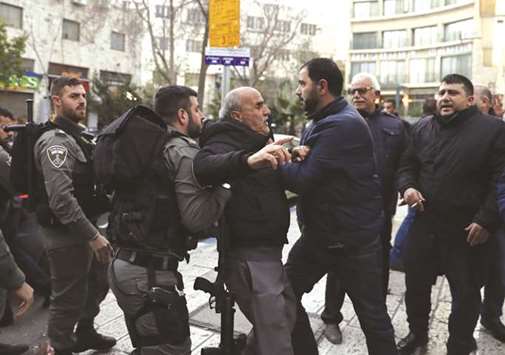 Israeli security forces restrain a Palestinian protester during a small protest in east Jerusalem, yesterday.