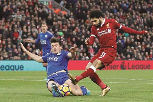 Liverpoolu2019s Mohamed Salah (right) in action with Leicester Cityu2019s Harry Maguire during their English Premier League match yesterday. (Reuters)