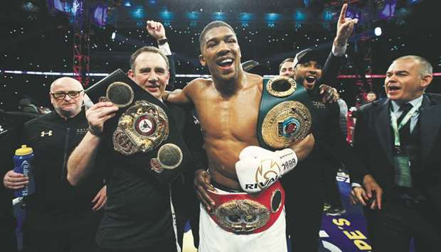 In this April 29, 2017, picture, Britain's Anthony Joshua celebrates with trainer Robert McCracken after winning the bout against Wladimir Klitschko at the Wembley Stadium in London, England. (Reuters)