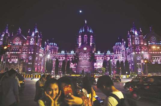 People take pictures in front of the Chattrapathi Shivaji Terminus (CST) railway station ahead of New Yearu2019s eve celebrations in Mumbai yesterday.