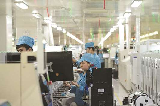 Employees work at the main factory of Chinese smartphone maker Oppo in Dongguan. Growth in Chinau2019s manufacturing sector slowed slightly in December as a punishing crackdown on air pollution and a cooling property market start to weigh on the worldu2019s second-largest economy.