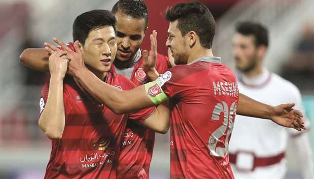Al Duhailu2019s Korean star Nam Tae-hee is congratulated by Youusef Msakni and Youssef El Arabi after he scored the winner for his team yesterday.