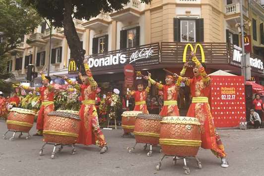 Performers beat drums during the opening ceremony of the first McDonaldu2019s fast food chain restaurant in Hanoi on Saturday.