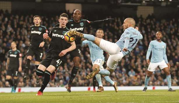 Manchester Cityu2019s David Silva scores their second goal during their English Premier League match against West Ham United in Manchester, England, yesterday. (Reuters)
