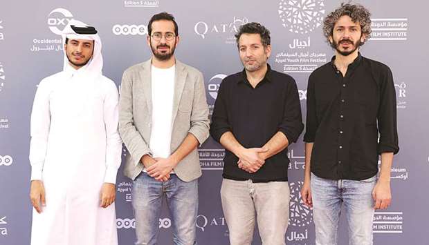Short film makers Khalifa al-Marri, Karim Rahbani, Jeremie Reichenbach, Ahmad Saleh pose for photographs during the Ajyal Youth Film Festival.PICTURES: Tim P Whitby/Getty Images