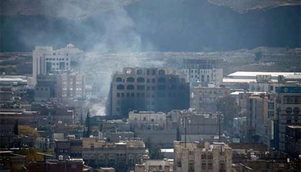 Smoke billows behind a building in the Yemeni capital Sanaa on Sunday.