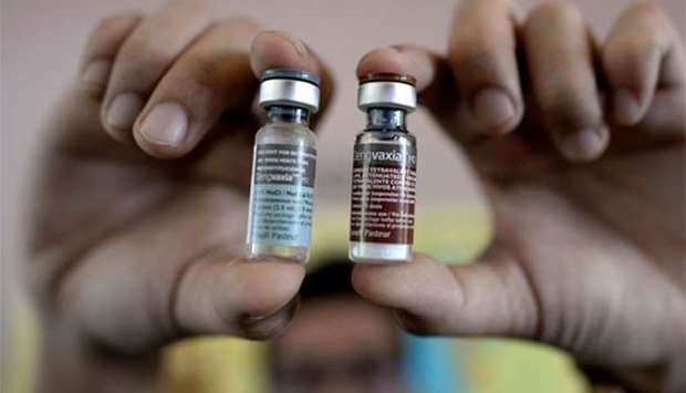 A nurse shows vials of the anti-dengue vaccine Dengvaxia.