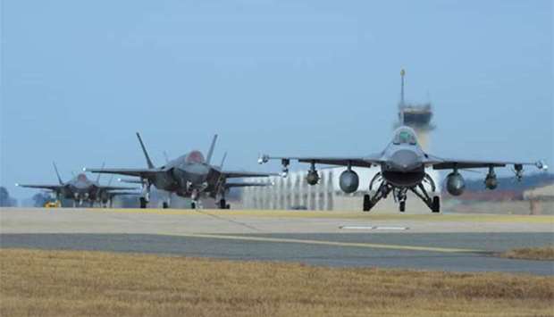 US Air Force F-16 Fighting Falcon (right) and F-35A Lightning II fighter jets taxiing at Kunsan Air Base in Gunsan, South Korea.