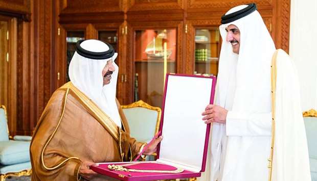 His Highness the Emir Sheikh Tamim bin Hamad al-Thani presents Hamad bin Khalifa Sash to former speaker of the Advisory Council Mohamed bin Mubarak Al Khulaifi.