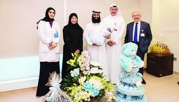 HE the Minister of Public Health Dr Hanan Mohamed al-Kuwari,. along with officials, presents a special gift to the first Qatari baby born at HMCu2019s new Womenu2019s Wellness and Research Center.