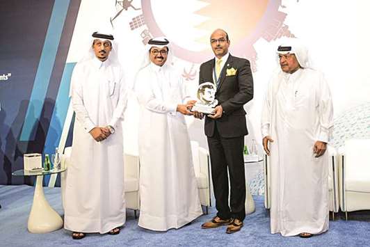HE the Minister for Energy and Industry Dr Mohamed bin Saleh al-Sada handing over the recognition award to Vodafone.
