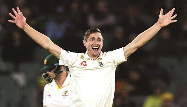 Englandu2019s paceman Chris Woakes celebrates dismissing Australiau2019s Steve Smith (L) on the third day of the second Ashes Test in Adelaide yesterday.