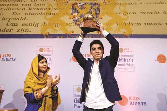 16-year old Syrian Mohamed al-Jounde (right) celebrates after receiving the International Childrenu2019s Peace Prize, given to him by Pakistani activist and Nobel Peace Prize laureate Malala Yousafzai yesterday, at the Ridderzaal in The Hague.