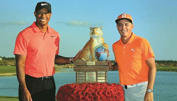 Rickie Fowler (right) of the United States poses with tournament host Tiger Woods and the trophy after winning the Hero World Challenge in Nassau, Bahamas. (Getty Images/AFP)