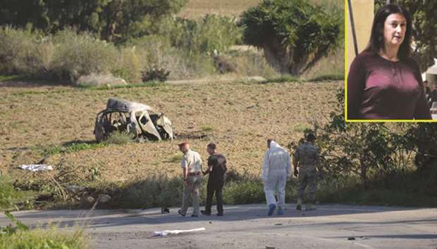 This picture taken on October 16 shows police officers and forensic experts inspect the wreckage of a car bomb in which journalist and blogger Daphne Caruana Galizia (pictured right) was killed, close to her home in Bidnija, Malta.