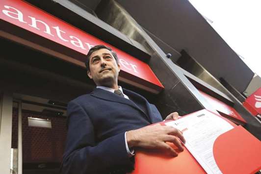 Catalan National Assembly (ANC) treasurer Marcel Padros shows a bank receipt after paying the bails for the release of some Catalan former ministers, in front of a Banco Santander branch in Barcelona.