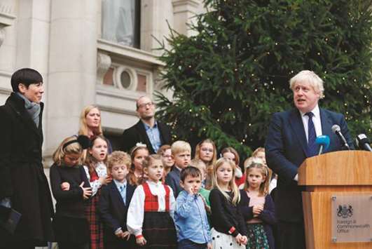 Norwayu2019s Foreign Secretary Ine Eriksen Soreide (left) listens as Foreign Secretary Boris Johnson speaks during the unveiling of a Christmas tree, gifted by Norway, outside The Foreign and Commonwealth Office (FCO) in London yesterday. Johnson met Norwayu2019s Foreign Secretary Ine Eriksen Soreide for bilateral talks before a ceremony to handover the tree.