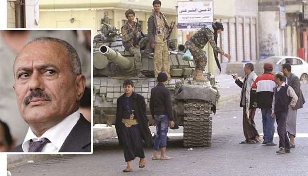 INSERT PHOTO: Ali Abdullah Saleh.  RIGHT: Houthi rebel fighters are seen riding a tank outside of the residence of Yemenu2019s former President Ali Abdullah Saleh in Sanaa yesterday.