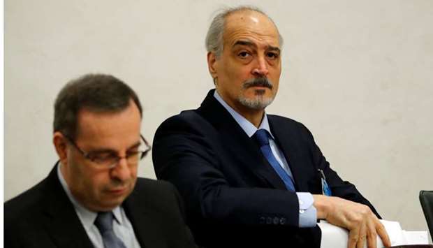 Syria's UN ambassador and chief negotiator Bashar al-Ja'afari (R) arrives for a meeting with United Nations Special Envoy for Syria Staffan de Mistura during the Intra Syria talks in Geneva, Switzerland December 1, 2017
