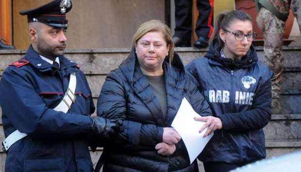 Maria Angela Di Trapani (C), a female mobster suspected of being the mastermind behind a reshuffle of the Sicilian Mafia following the death of ,boss of bosses, Toto Riina, is escorted by carabinieri during a police operation, on December 5, 2017 in Palermo. AFP