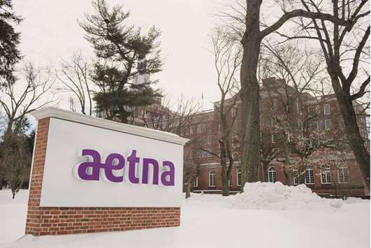 Snow covers the ground around Aetna signage displayed outside of the companyu2019s corporate headquarters in Hartford, Connecticut. CVS, based in Woonsocket, Rhode Island, made its move on Aetna less than a year after two major health-insurance takeovers were blocked by the Justice Department on antitrust grounds.