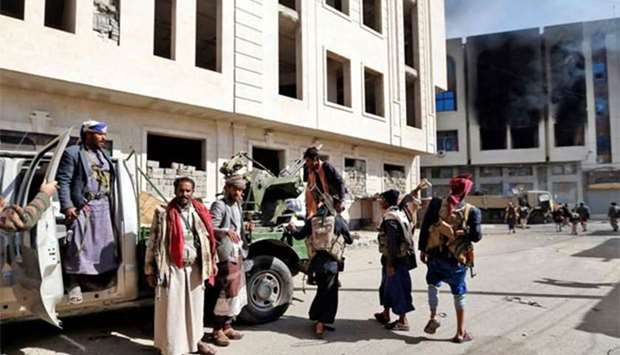 Houthi rebel fighters are seen in front of the residence of Yemen's former president Ali Abdullah Saleh in Sanaa on Monday.