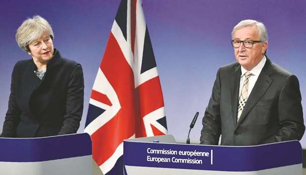 British Prime Minister Theresa May and European Commission chief Jean-Claude Juncker give a press conference as they meet for Brexit negotiations on December 4, at the European Commission in Brussels.