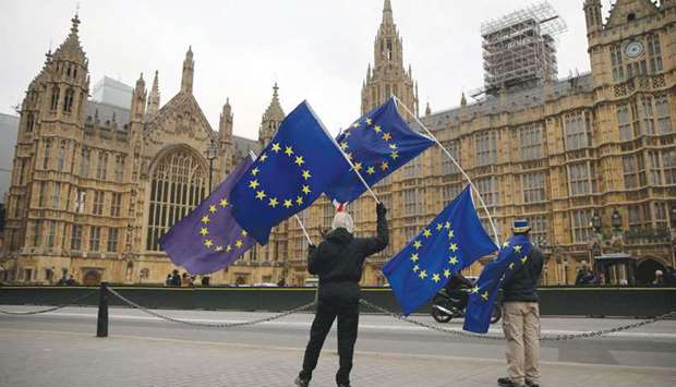 A demonstrator waves EU flags outside the Houses of Parliament in Westminster, central London, yesterday.