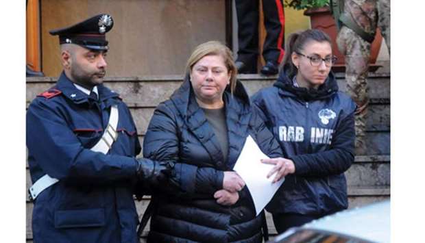 Maria Angela Di Trapani is escorted by carabinieri yesterday.