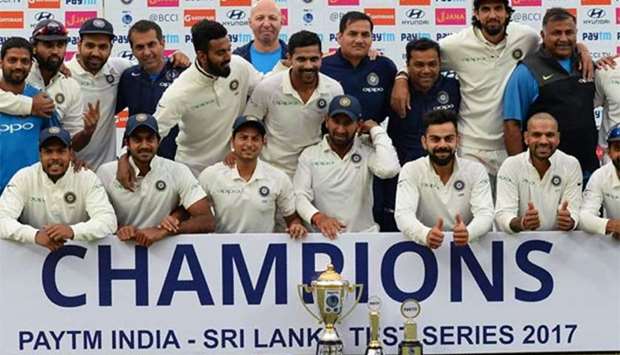 The Indian cricket team pose with the trophy after winning the Test series against Sri Lanka at the Feroz Shah Kotla Stadium in New Delhi on Wednesday.