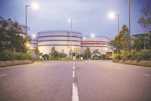 China Petroleum & Chemical Corp storage tanks stand in Hong Kong. Sinopec has hired BNP Paribas to sell its oil business in Nigeria and Gabon as the state-owned oil giant pares back its presence in Africa.