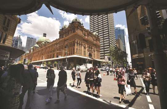Pedestrians and shoppers are seen on a street in the central business district of Sydney. Australiau2019s economy grew 0.6% in the third-quarter, as business investment lifted despite weak household spending, reflecting the divergence between the two segments, official data showed yesterday.