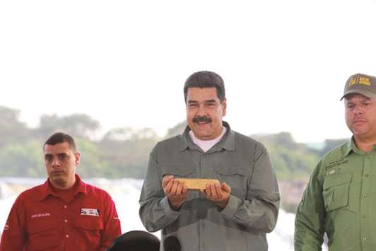 Venezuelau2019s President Nicolas Maduro holds a gold bar during a meeting with representatives of the mining sector in Puerto Ordaz, Venezuela.
