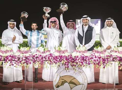 QREC Board member Abdullah Mohamed al-Sheikh al-Kuwari (second from right) with the winners of the Al Daayen Cup after MJ Lattam won the race at the QREC yesterday. PICTURES: Juhaim