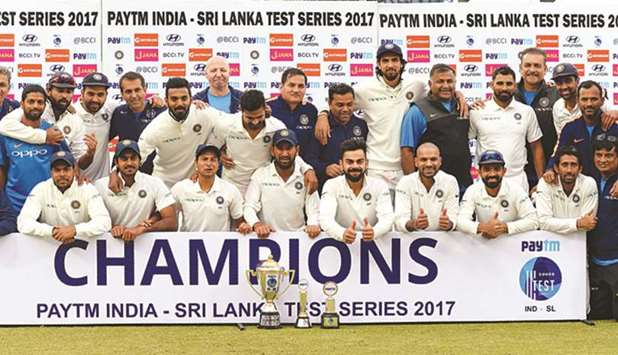 Indian players pose with the trophy after winning the Test series against Sri Lanka at the Feroz Shah Kotla Stadium in New Delhi yesterday. (AFP)