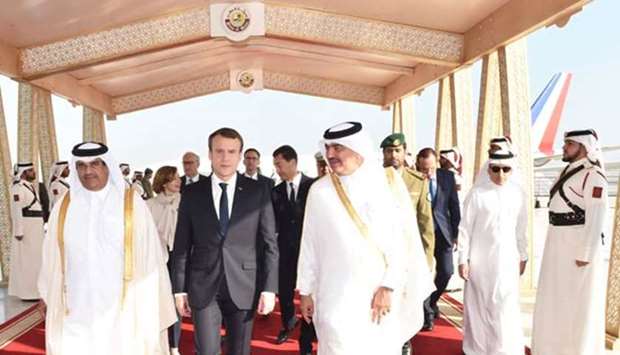 French President Emmanuel Macron is seen with HE the Minister of Municipality and Environment Mohammed bin Abdullah al-Rumaihi and dignitaries at the Hamad International Airport on Thursday.