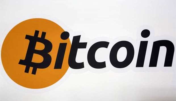 A Bitcoin logo is displayed at the Bitcoin Center New York City.