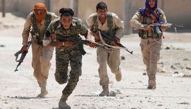 Fighters battle against Islamic State in Raqqa, Syria