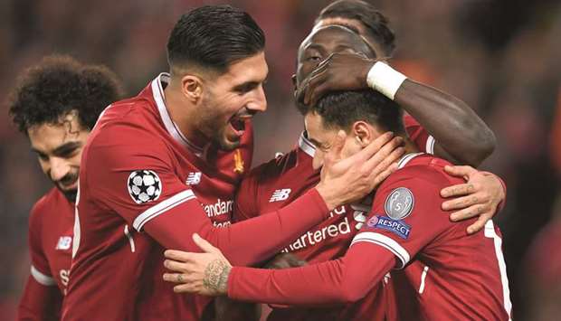 Liverpoolu2019s Brazilian midfielder Philippe Coutinho (right) celebrates after completing his hat-trick with teammate Emre Can (left) during the UEFA Champions League Group E match against Spartak Moscow at Anfield in Liverpool. (AFP)