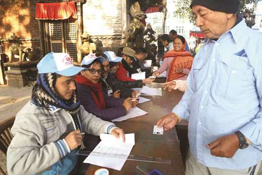 People get ready to cast their vote at a polling station in Kathmandu yesterday.