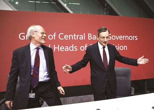 ECB president Mario Draghi (right) gestures as Stefan Ingves, governor of the Sveriges Riksbank and chairman of the Basel Committee, reacts at a Basel III capital rules news conference at the ECB headquarters in Frankfurt yesterday. u201cThe focus of the reforms was to reduce regulatory uncertainty. Now itu2019s time is for implementation and not further design,u201d Draghi told the conference.