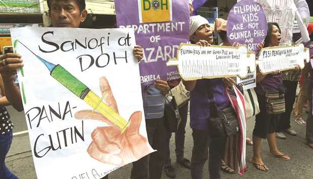 Members and supporters of the womenu2019s group Gabriela display placards and shout slogans during a rally in front of the Department of Health office in Manila earlier this month.