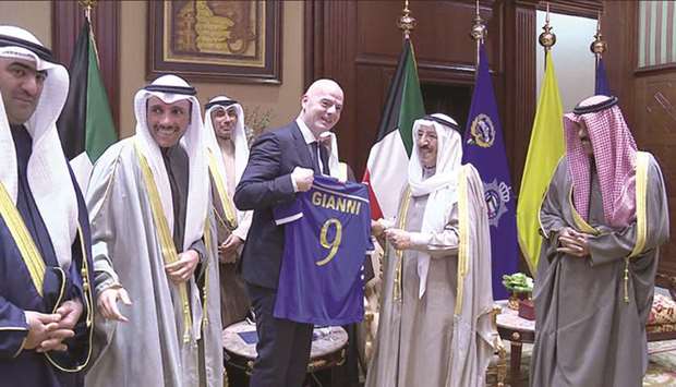 The Emir of Kuwait Sheikh Sabah al-Ahmad al-Jaber al-Sabah presenting FIFA president Gianni Infantino with a Kuwaiti national team kit, bearing his name in Kuwait City yesterday.