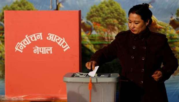 A woman casts her vote during the parliamentary and provincial elections in Bhaktapur, Nepal on Thursday.