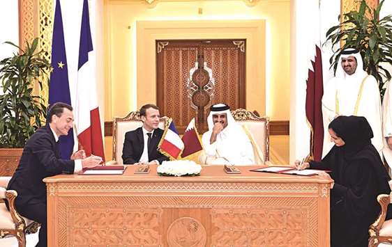 His Highness the Emir Sheikh Tamim bin Hamad al-Thani and French President Emmanuel Macron witness the signing of an agreement between Qatar and France at the Emiri Diwan yesterday.