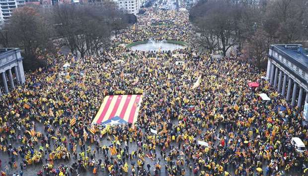 People wave a giant Catalan u2018Esteladau2019 flag during the pro-independence demonstration yesterday in Brussels.