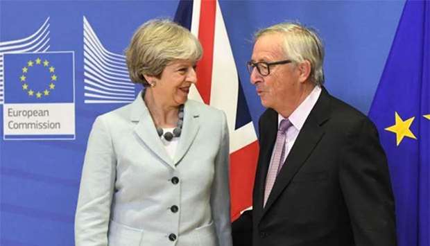 British Prime Minister Theresa May is welcomed by European Commission Jean-Claude Juncker at European Commission in Brussels on Friday.